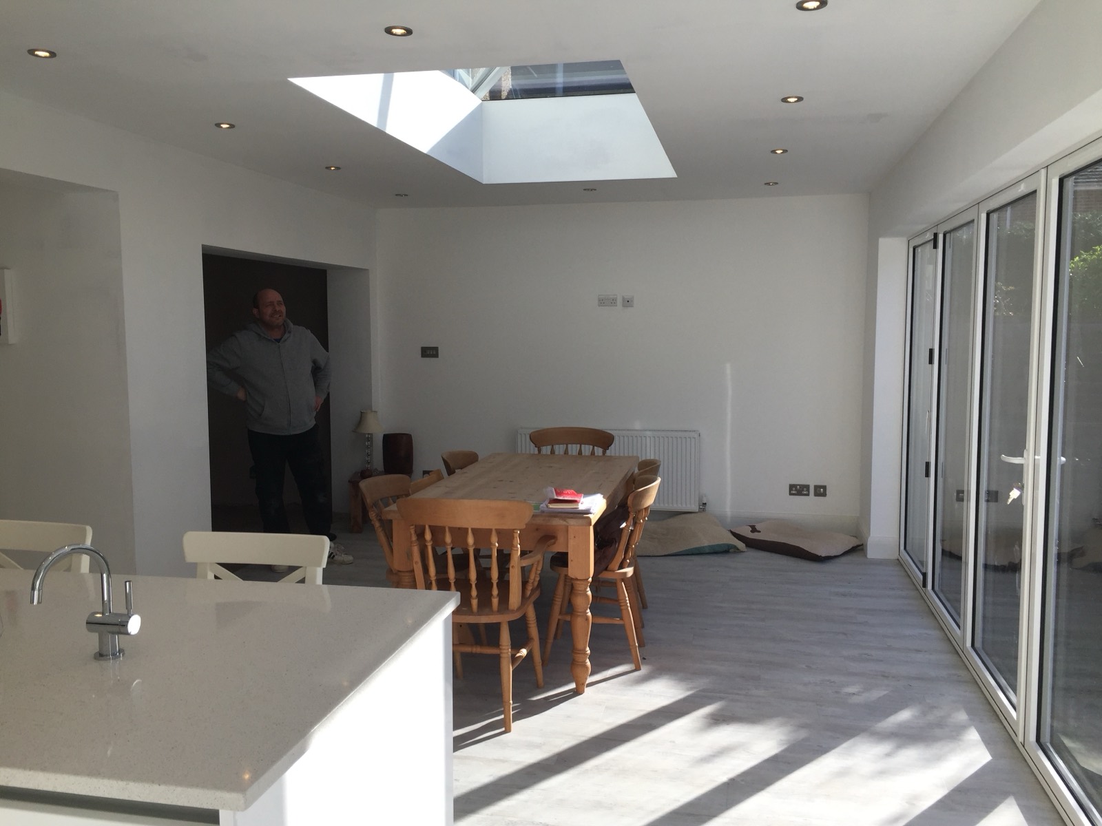 Downlights set into a new open-plan extension around a roof lantern — first-fix to final test on an extension project.